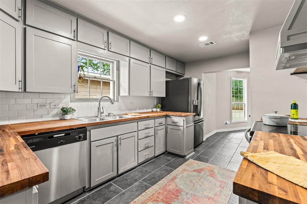 3116 Alexander Avenue Waco, TX 76708 - Photo 13 of 40 a large kitchen with stainless steel appliances granite countertop a sink stove and refrigerator