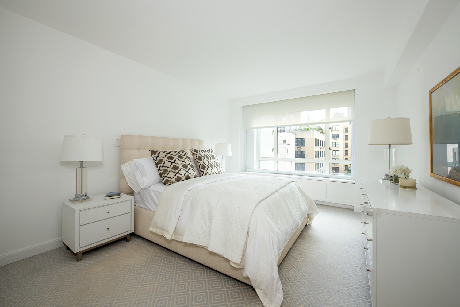 799 Park Avenue, Unit 9A Manhattan, NY 10021 - Photo 10 of 14 a bedroom with bed and a large window