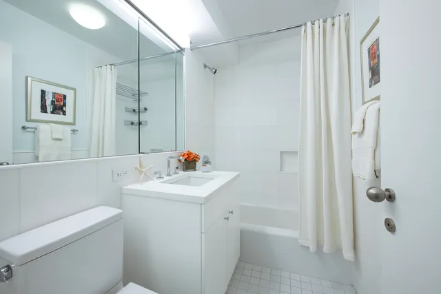 a bedroom with bed and a large window