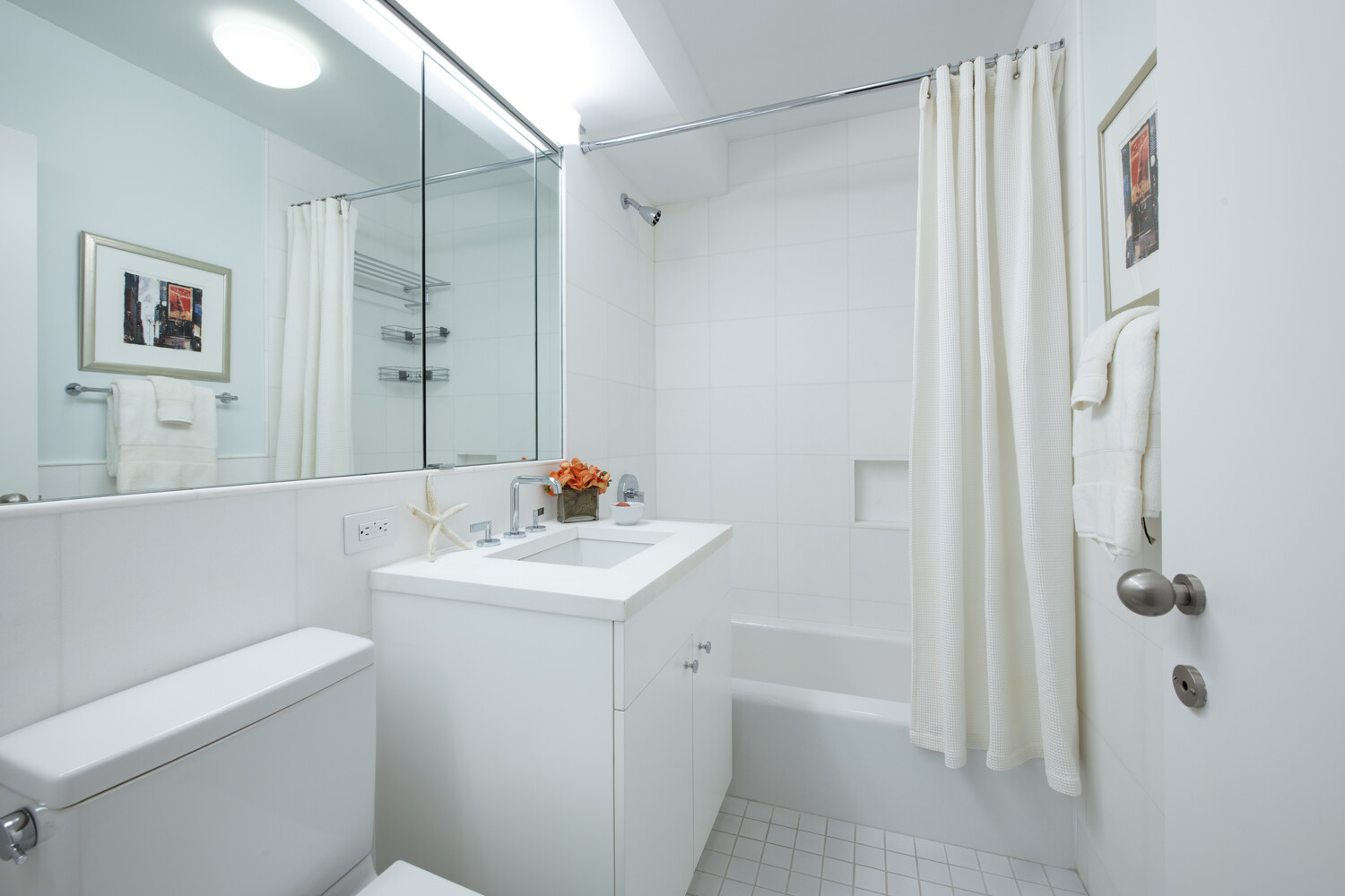 799 Park Avenue, Unit 9A Manhattan, NY 10021 - Photo 11 of 14 a bathroom with a sink a toilet and shower