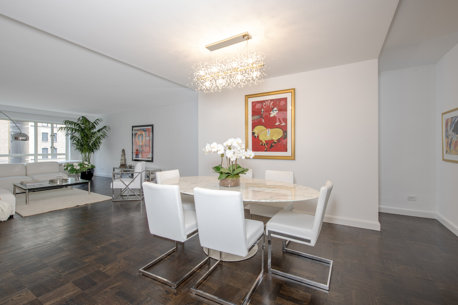 799 Park Avenue, Unit 9A Manhattan, NY 10021 - Photo 3 of 14 a view of a dining room with furniture and chandelier