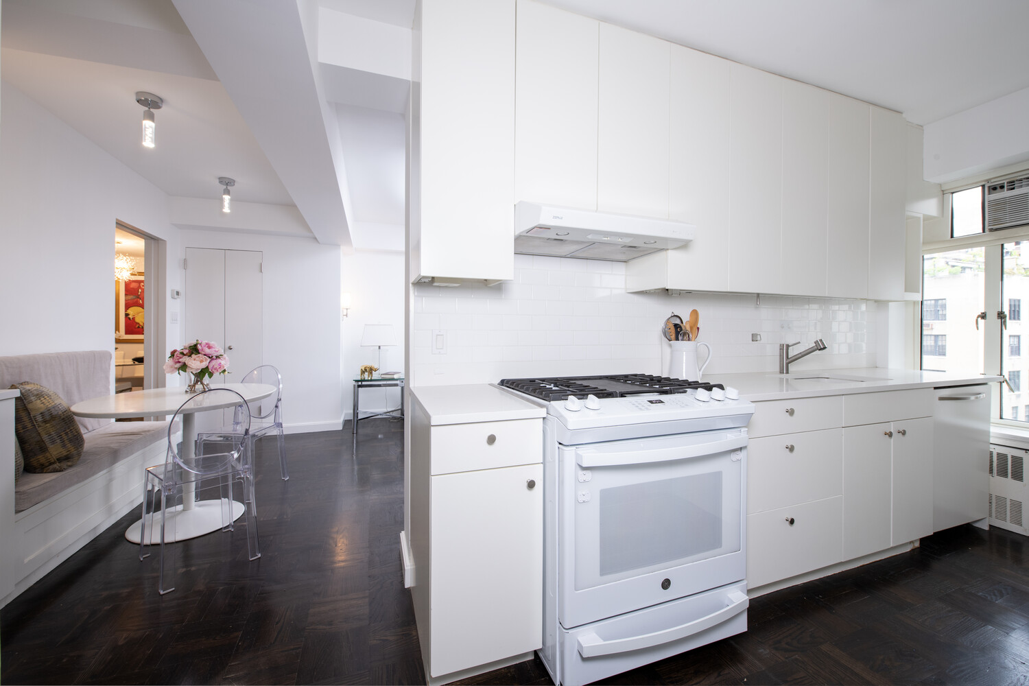 799 Park Avenue, Unit 9A Manhattan, NY 10021 - Photo 6 of 14 a kitchen that has a lot of white cabinets and wooden floor