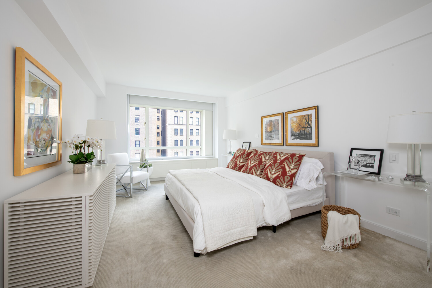 799 Park Avenue, Unit 9A Manhattan, NY 10021 - Photo 8 of 14 a bedroom with a bed lamp and a large window