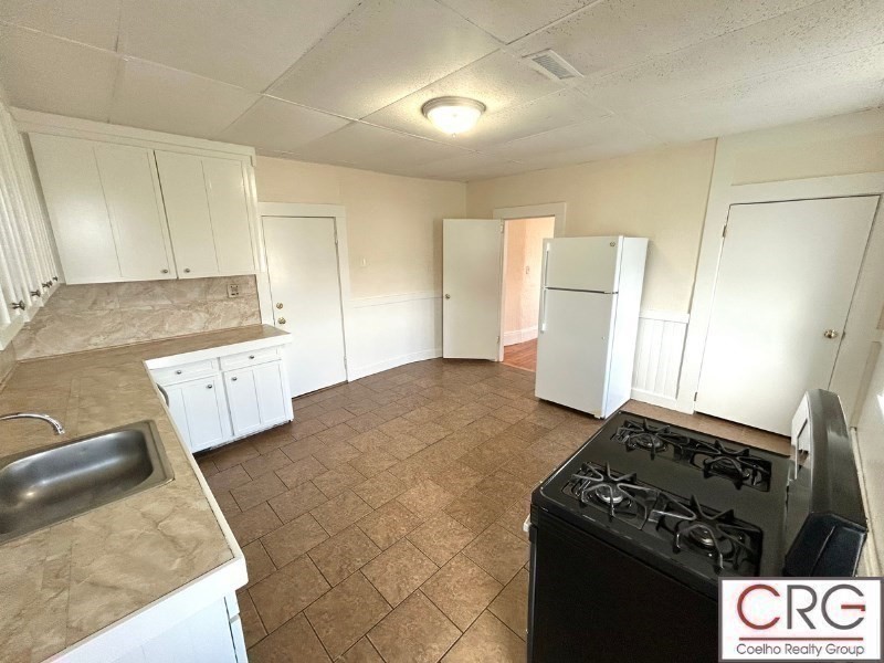 31 Elmwood Street, Unit 6 Revere, MA 02151 - Photo 11 of 16 a kitchen with granite countertop a stove and a refrigerator