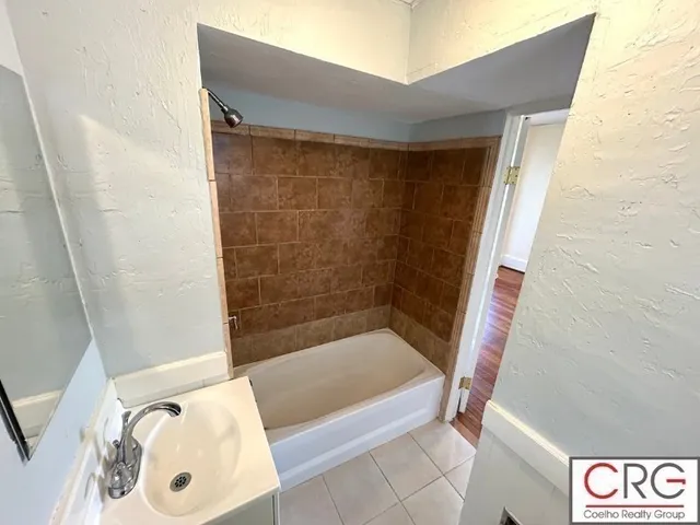 a bathroom with a bathtub and shower