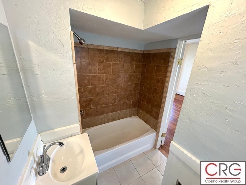31 Elmwood Street, Unit 6 Revere, MA 02151 - Photo 15 of 16 a bathroom with a bathtub and shower