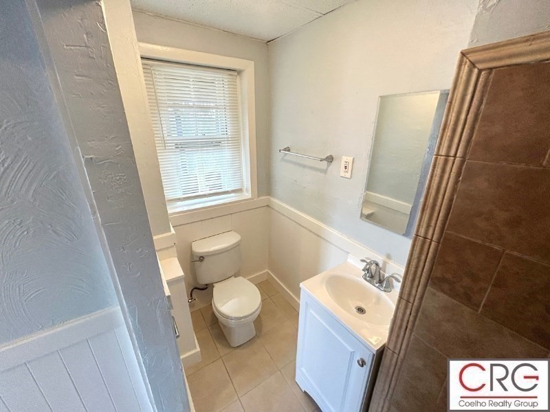 31 Elmwood Street, Unit 6 Revere, MA 02151 - Photo 16 of 16 a bathroom with a granite countertop sink toilet and shower