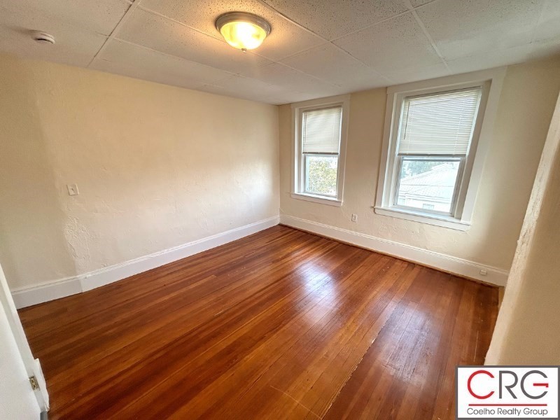 31 Elmwood Street, Unit 6 Revere, MA 02151 - Photo 4 of 16 a view of an empty room with wooden floor and a window