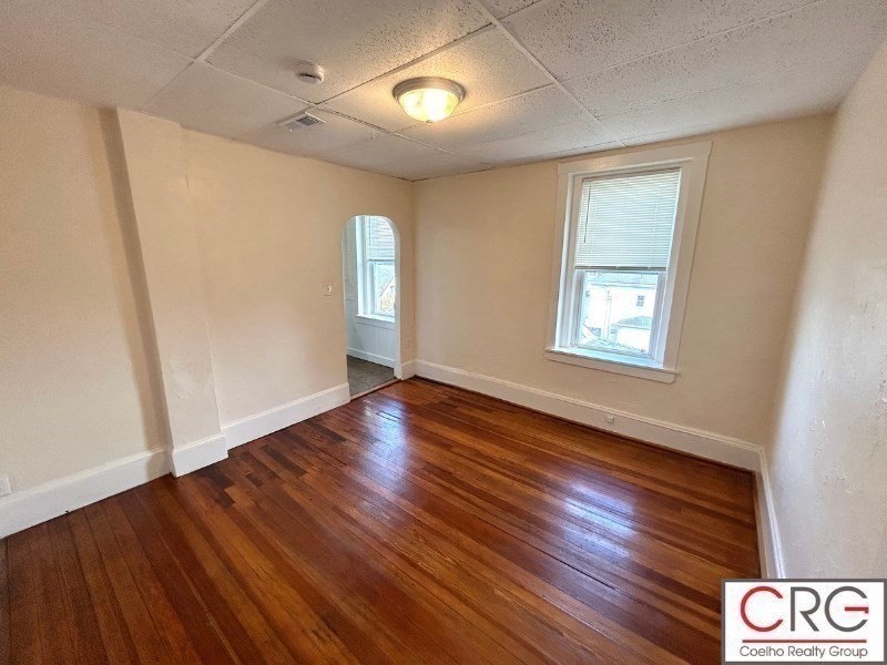 31 Elmwood Street, Unit 6 Revere, MA 02151 - Photo 7 of 16 an empty room with wooden floor and windows