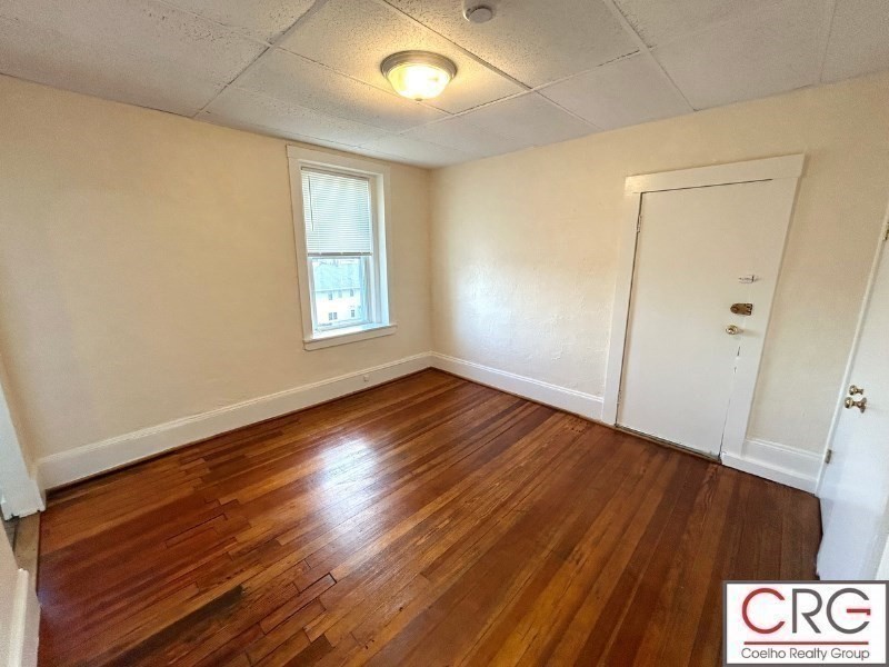 31 Elmwood Street, Unit 6 Revere, MA 02151 - Photo 8 of 16 an empty room with wooden floor and window