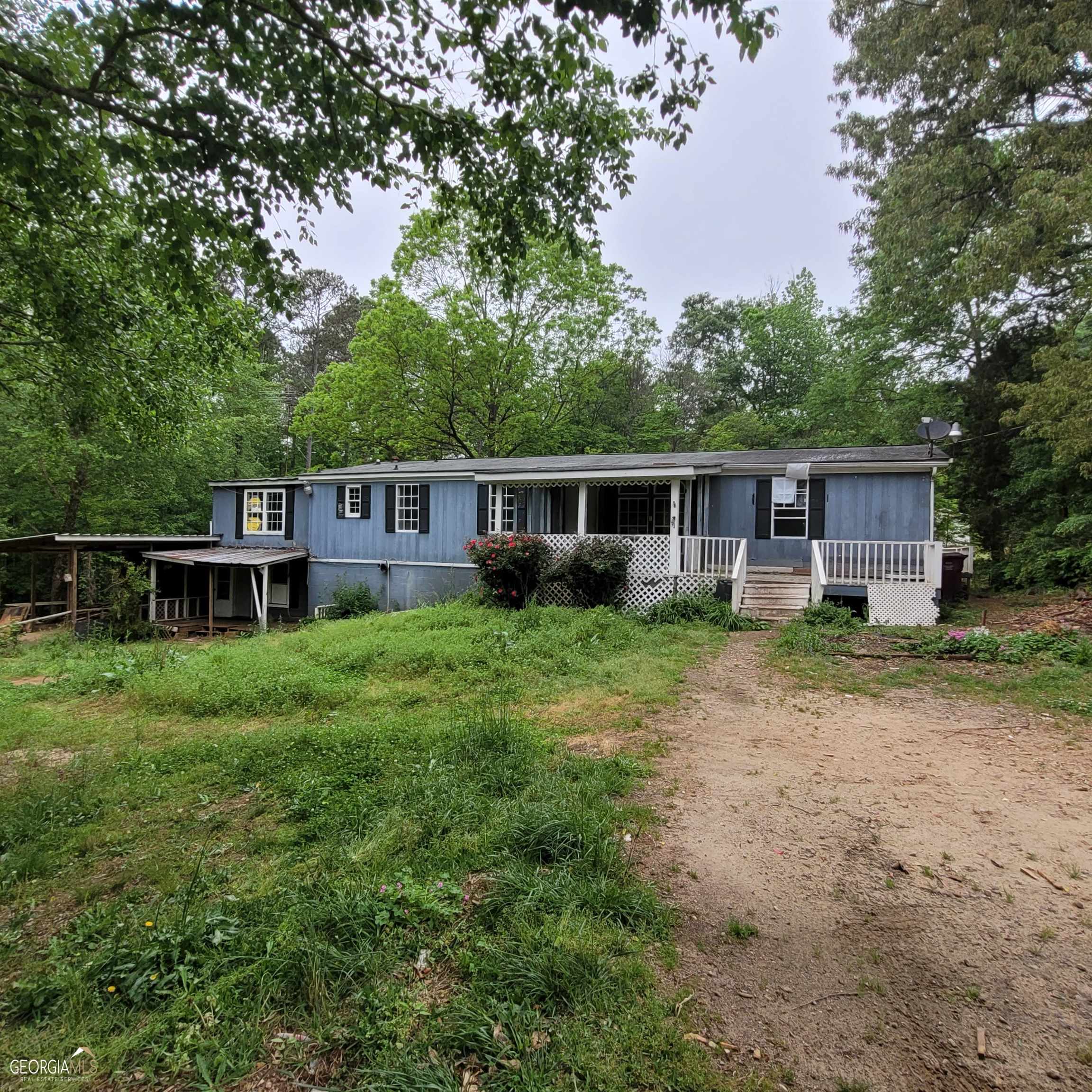11940 Flat Shoals Road Covington, GA 30016 - Photo 1 of 1 a view of a house with a backyard