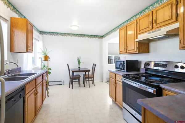 a kitchen with a stove a sink and a refrigerator