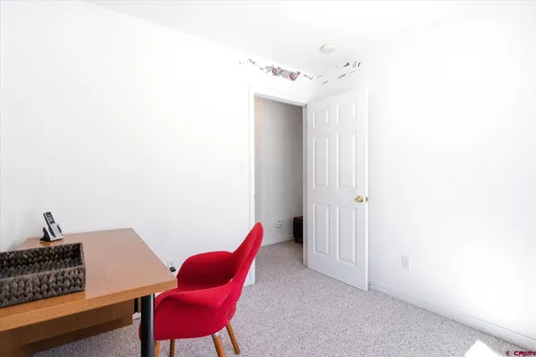 a living room with furniture and a chair