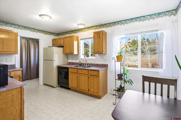 a spacious bathroom with a granite countertop sink and a large mirror