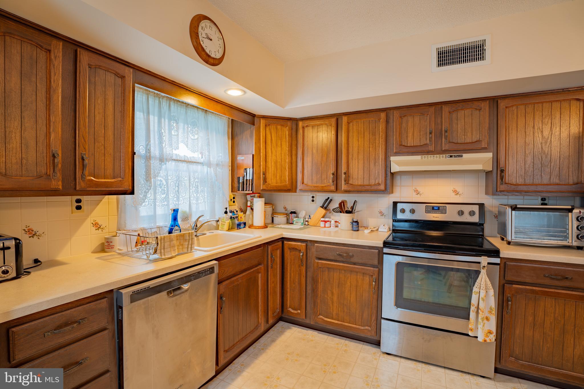 1776 1st Street Langhorne, PA 19047 - Photo 9 of 23 a kitchen with a sink stove and cabinets