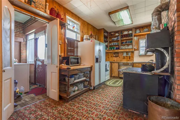 a dining room with furniture a chandelier and window