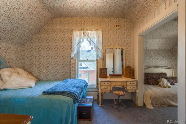 a living room with a bed furniture and a window