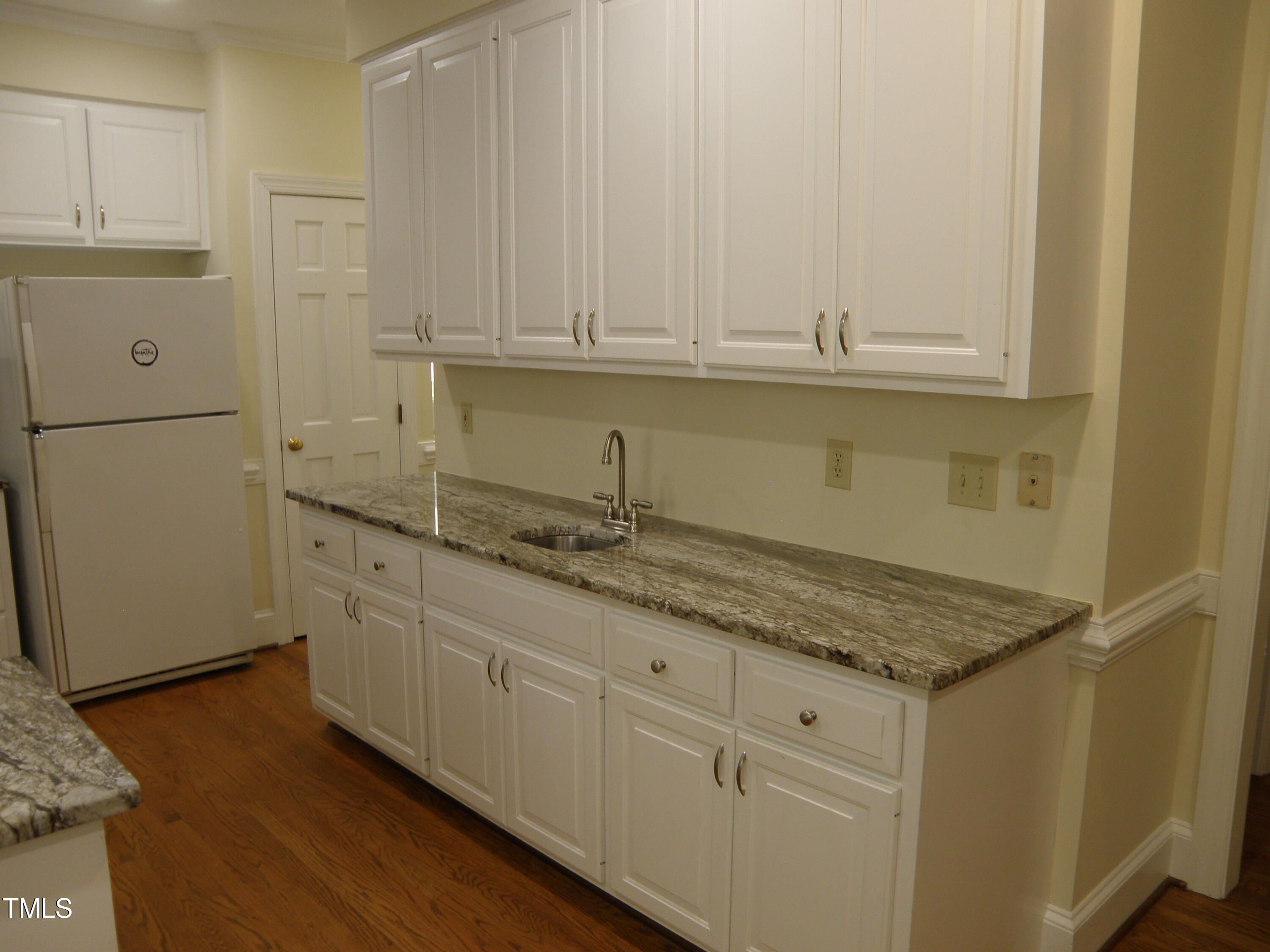 2532 Ashley Court Raleigh, NC 27607 - Photo 17 of 39 a kitchen with granite countertop white cabinets and a sink