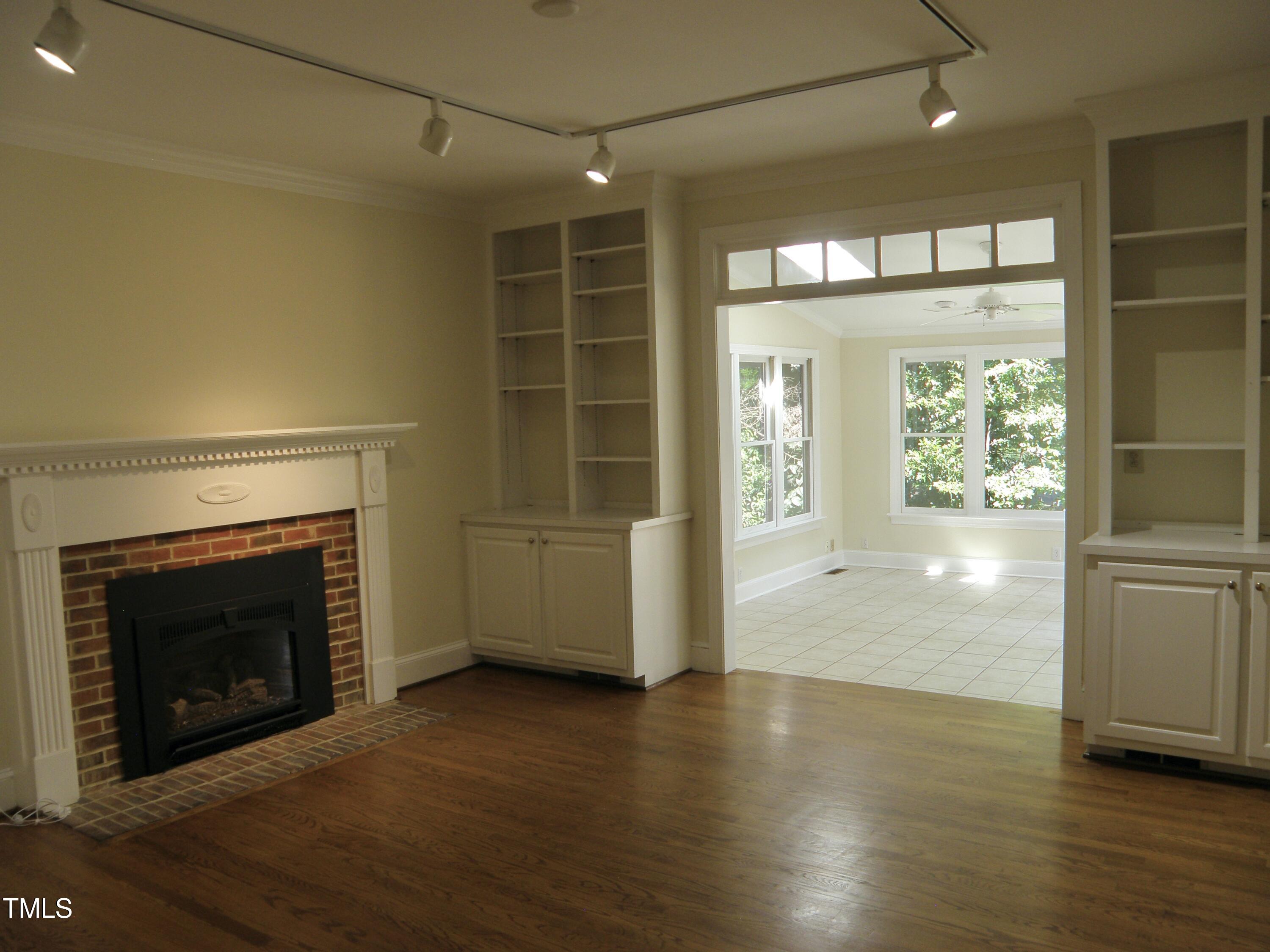 2532 Ashley Court Raleigh, NC 27607 - Photo 23 of 39 a view of an empty room with wooden floor and a window