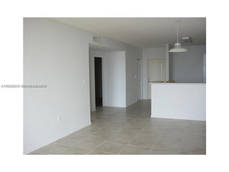 5099 Northwest 7th Street, Unit 1005 Miami, FL 33126 - Photo 16 of 35 a living room with a wooden floor