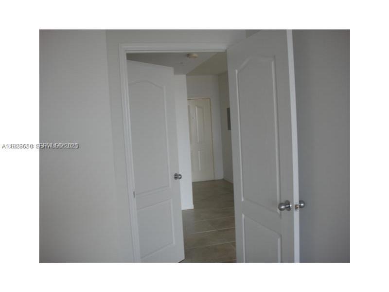 5099 Northwest 7th Street, Unit 1005 Miami, FL 33126 - Photo 17 of 35 a bathroom with a sink and a mirror