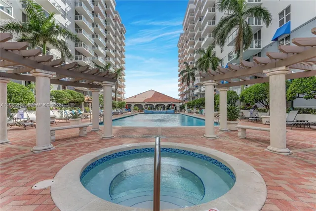 a swimming pool with outdoor seating