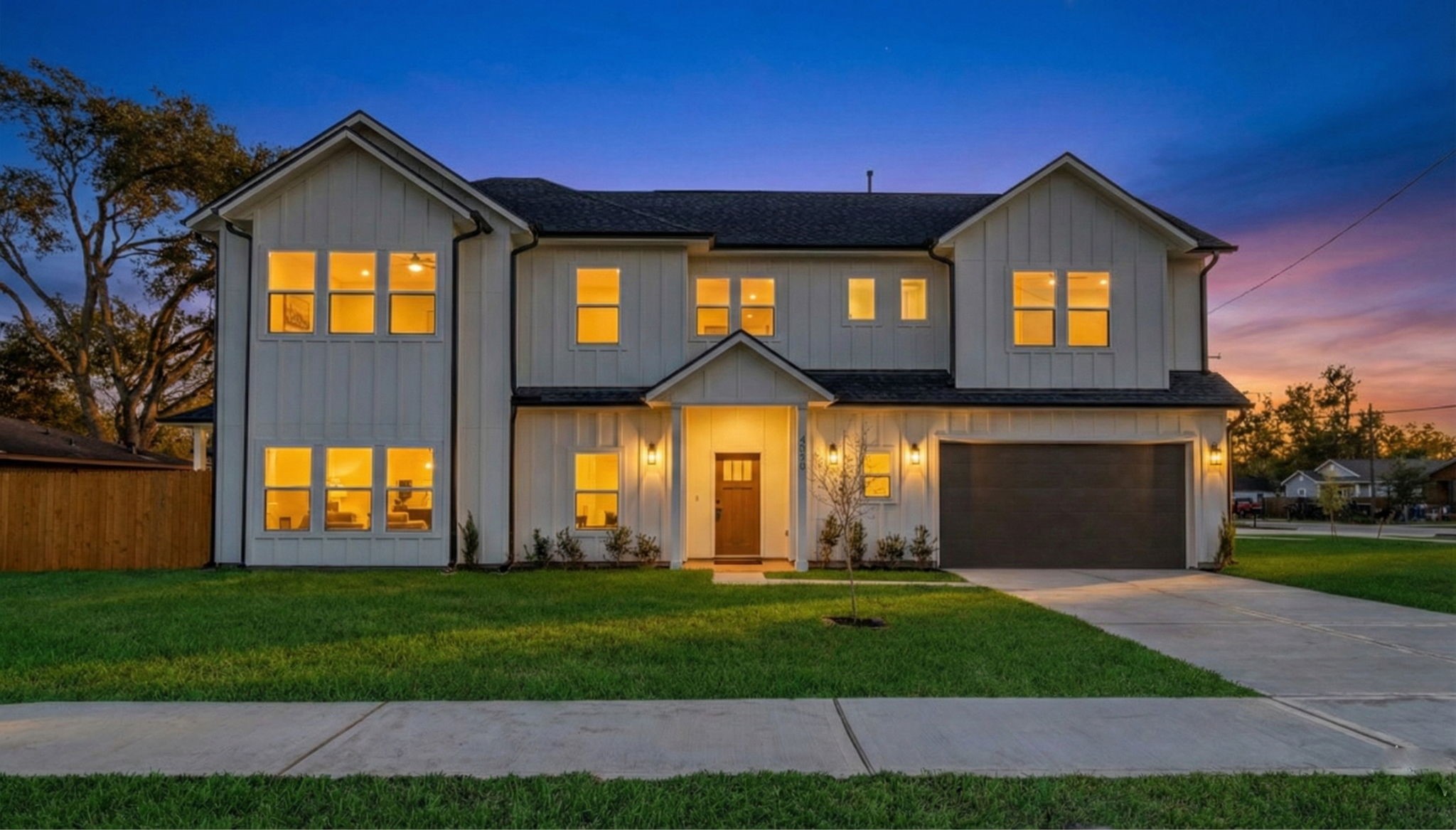 4202 Plaag Street Houston, TX 77016 - Photo 2 of 38 Stunning new construction with modern farmhouse design, showcased beautifully at dusk. Warm interior lighting highlights the inviting curb appeal.
