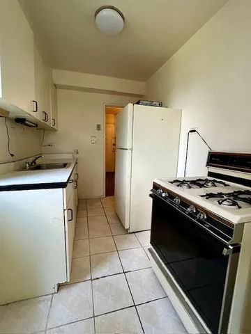 a kitchen with a stove top oven and cabinets
