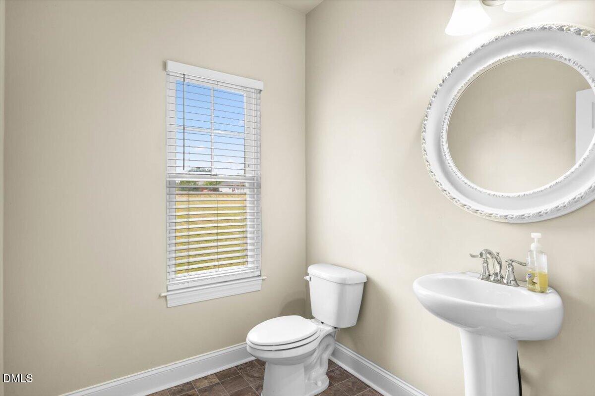 704 Haw River Hopedale Road Burlington, NC 27217 - Photo 10 of 49 a bathroom with a sink a mirror and a toilet