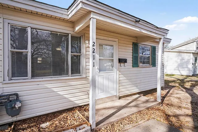 a view of a house with a door and wooden floor