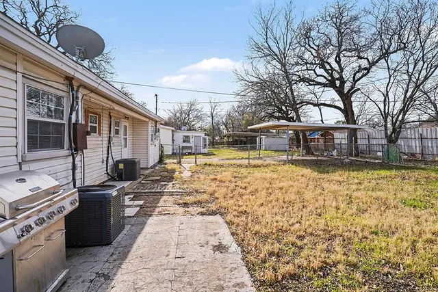 a view of a house with backyard stove and sitting area