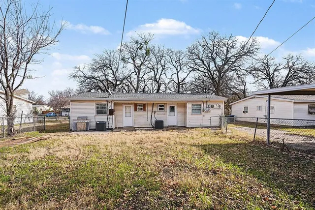 a house that has a tree in front of it