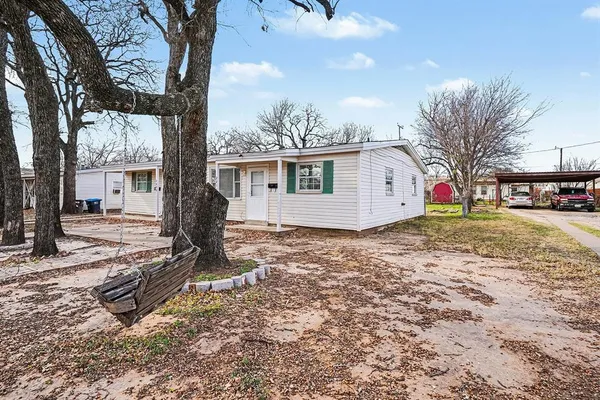 a view of a house with a yard covered in snow
