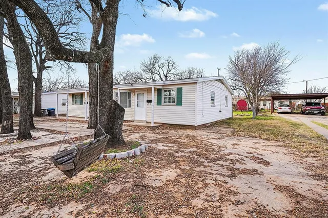 a view of a house with a yard covered in snow
