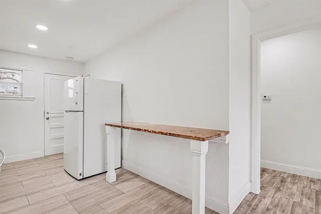 a view of a room with wooden floor