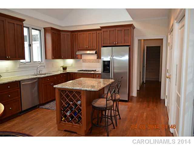 500 South Sharon Amity Road Charlotte, NC 28211 - Photo 5 of 16 a kitchen with stainless steel appliances granite countertop a sink refrigerator and cabinets