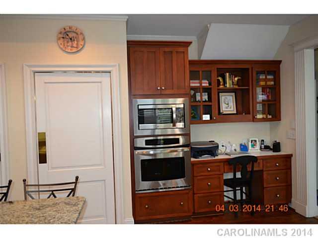500 South Sharon Amity Road Charlotte, NC 28211 - Photo 6 of 16 a kitchen with a refrigerator and a stove