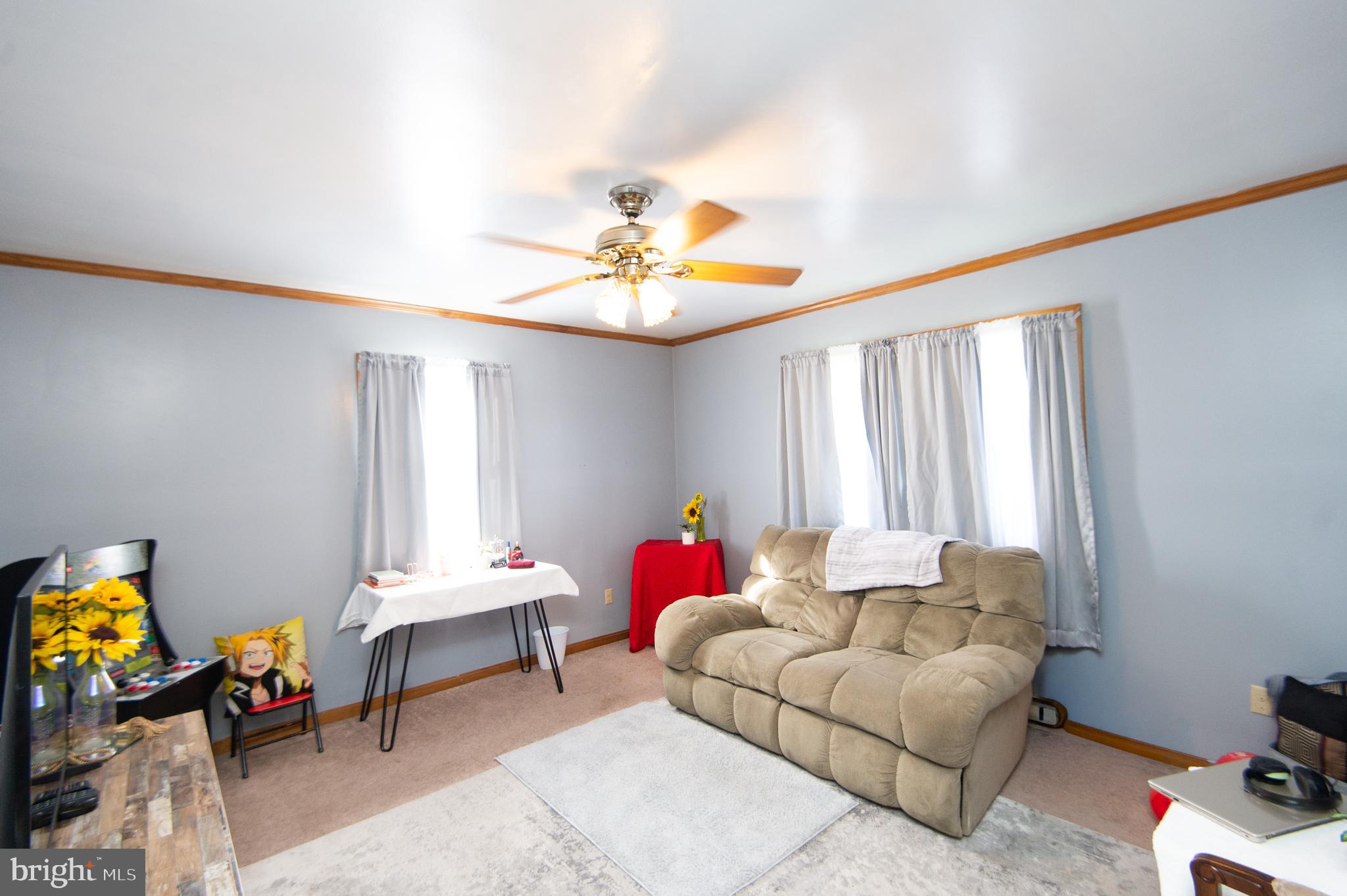 807 Bayly Road Cambridge, MD 21613 - Photo 15 of 36 a living room with furniture and a chandelier