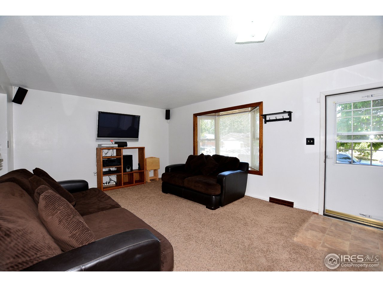 3334 West 4th Street Road Greeley, CO 80634 - Photo 4 of 34 a bedroom with a bed window and a television