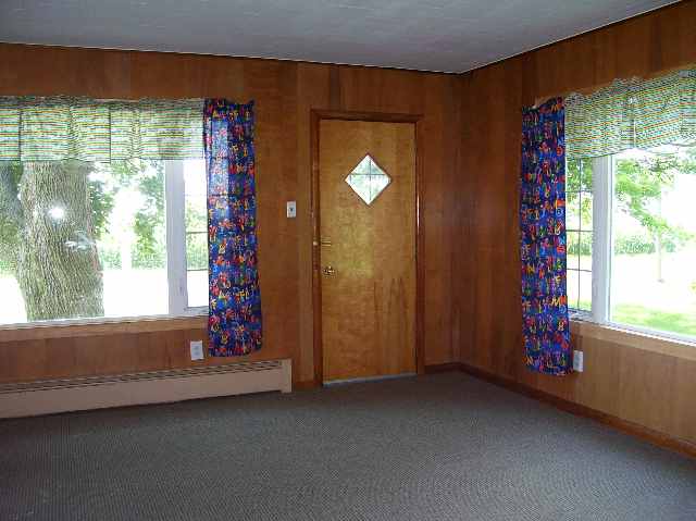 5676 School Road Chadwick, IL 61014 - Photo 3 of 5 a view of an empty room with a fireplace and a window