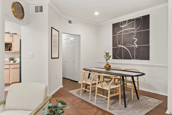 a living room with dining table and wooden floor