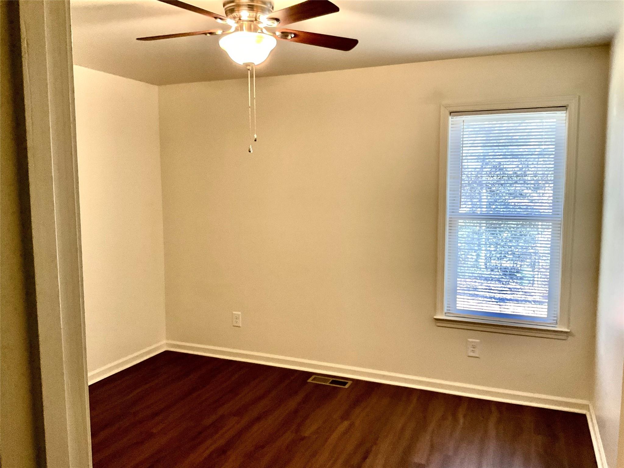 1285 Janice Road Lincolnton, NC 28092 - Photo 13 of 19 an empty room with wooden floor and windows