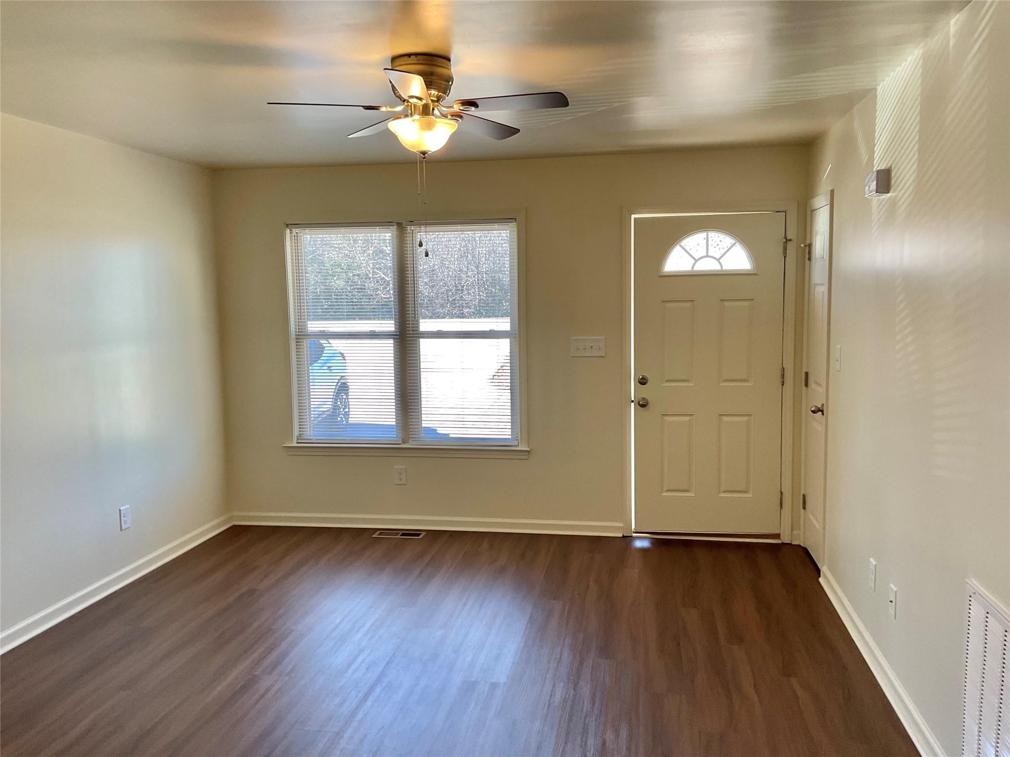 1285 Janice Road Lincolnton, NC 28092 - Photo 3 of 19 an empty room with wooden floor chandelier fan and windows