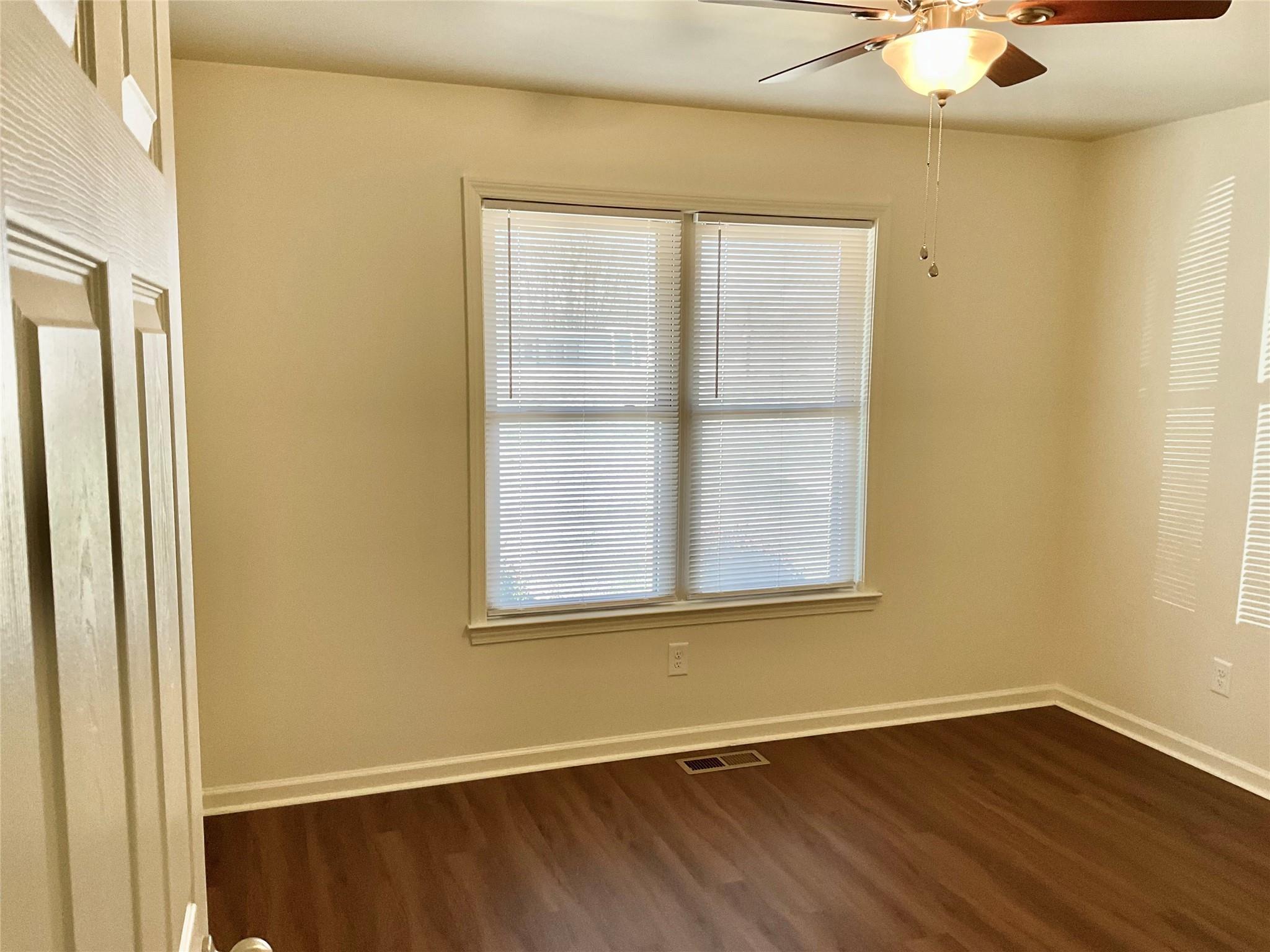 1285 Janice Road Lincolnton, NC 28092 - Photo 9 of 19 an empty room with wooden floor and windows
