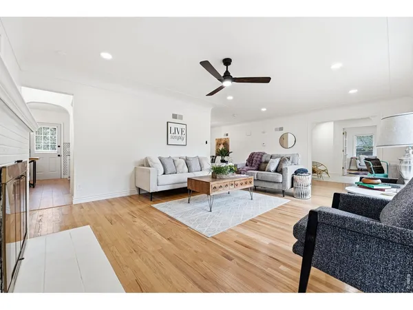 a living room with furniture and a wooden floor