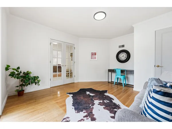 a living room with a couch a rug and a clock