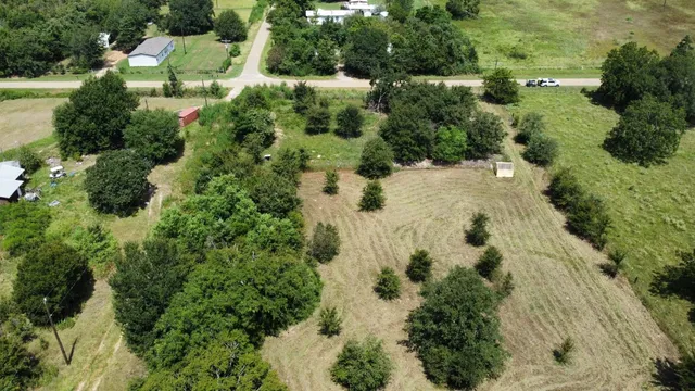 an aerial view of a house with a yard