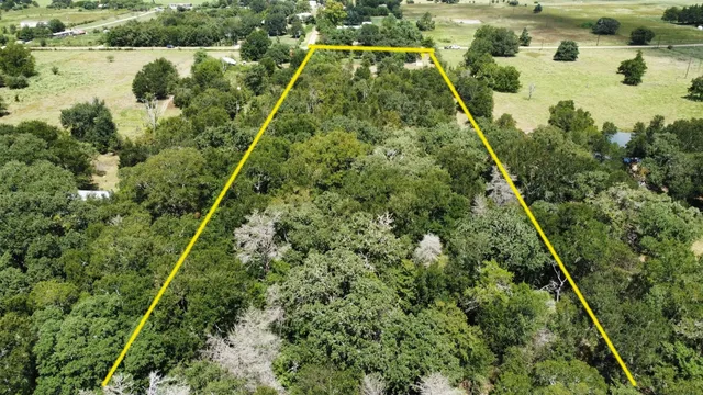 a aerial view of residential houses with outdoor space and lake view
