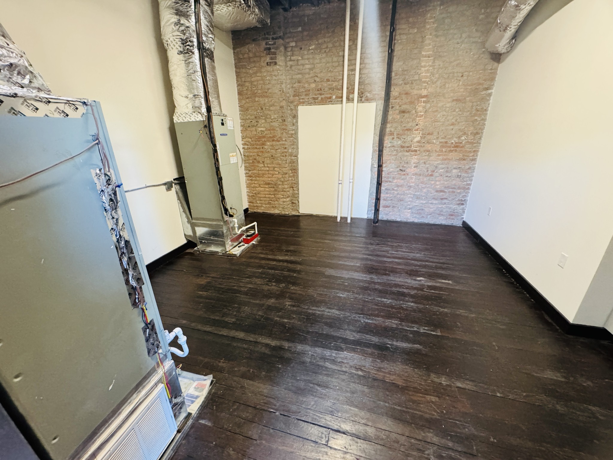 117 East Main Street Lebanon, TN 37087 - Photo 7 of 14 an empty room with wooden floor and windows