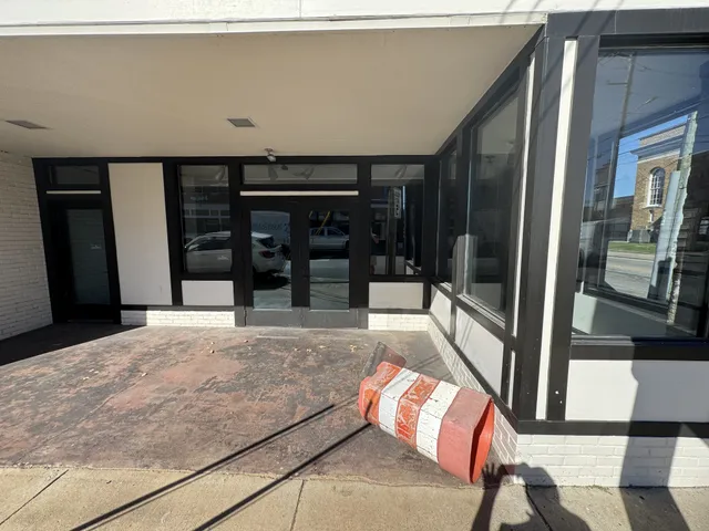 a view of building with car parked